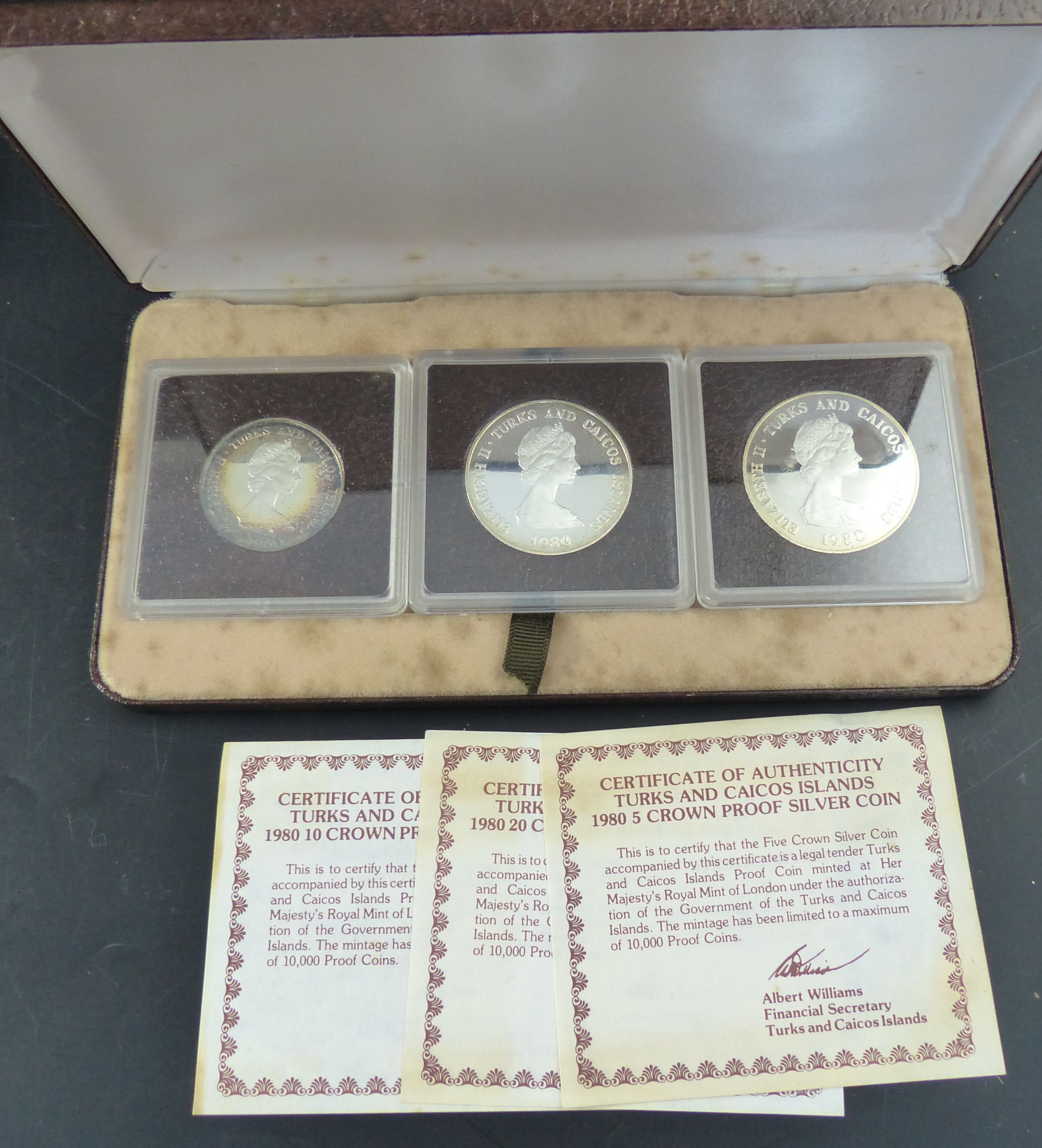 Three Turks and Caicos Islands proof coin sets, 1980 set of four 100 crown proof gold coin with 2010 and five crowns in silver;